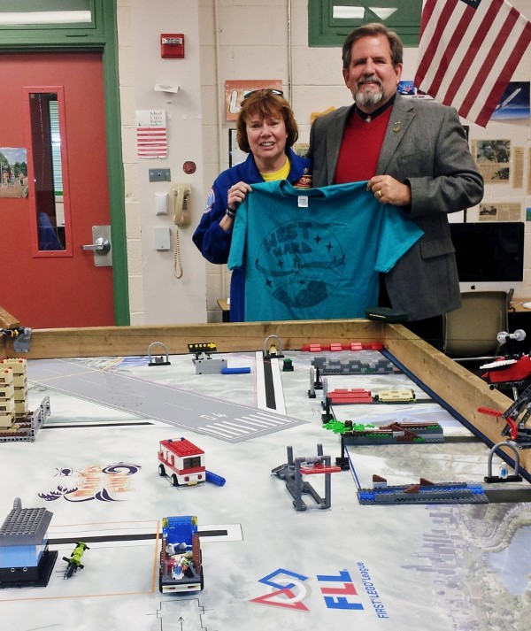 Dr. Kerry Crooks (r), an Airman’s Medal awardee, visits Adams at West Ward Elementary School to view the school's NASA Space Week displays. The school was awarded a $1,000 STEM Teaching Tools grant in October for its outstanding robotics program.